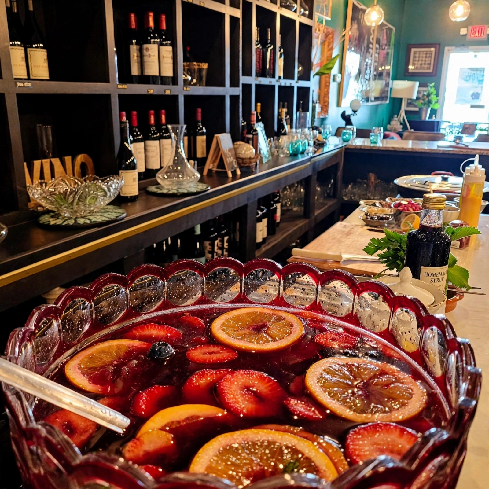A large ornate bowl of sangria with orange slices and strawberries on the Jordan's Wine Bar counter