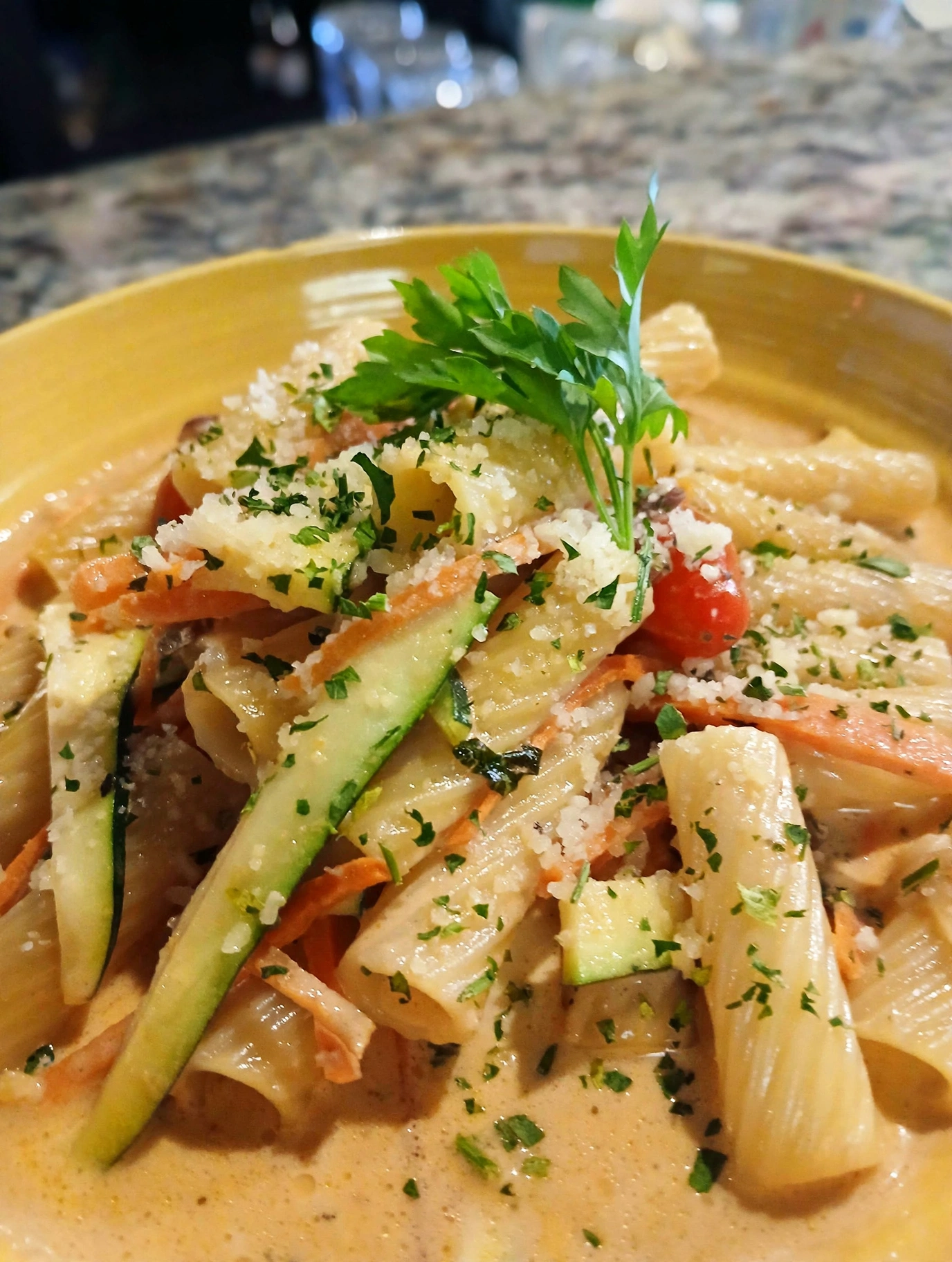 Rigatoni with zucchini, tomato and shaved cheese in a cream sauce